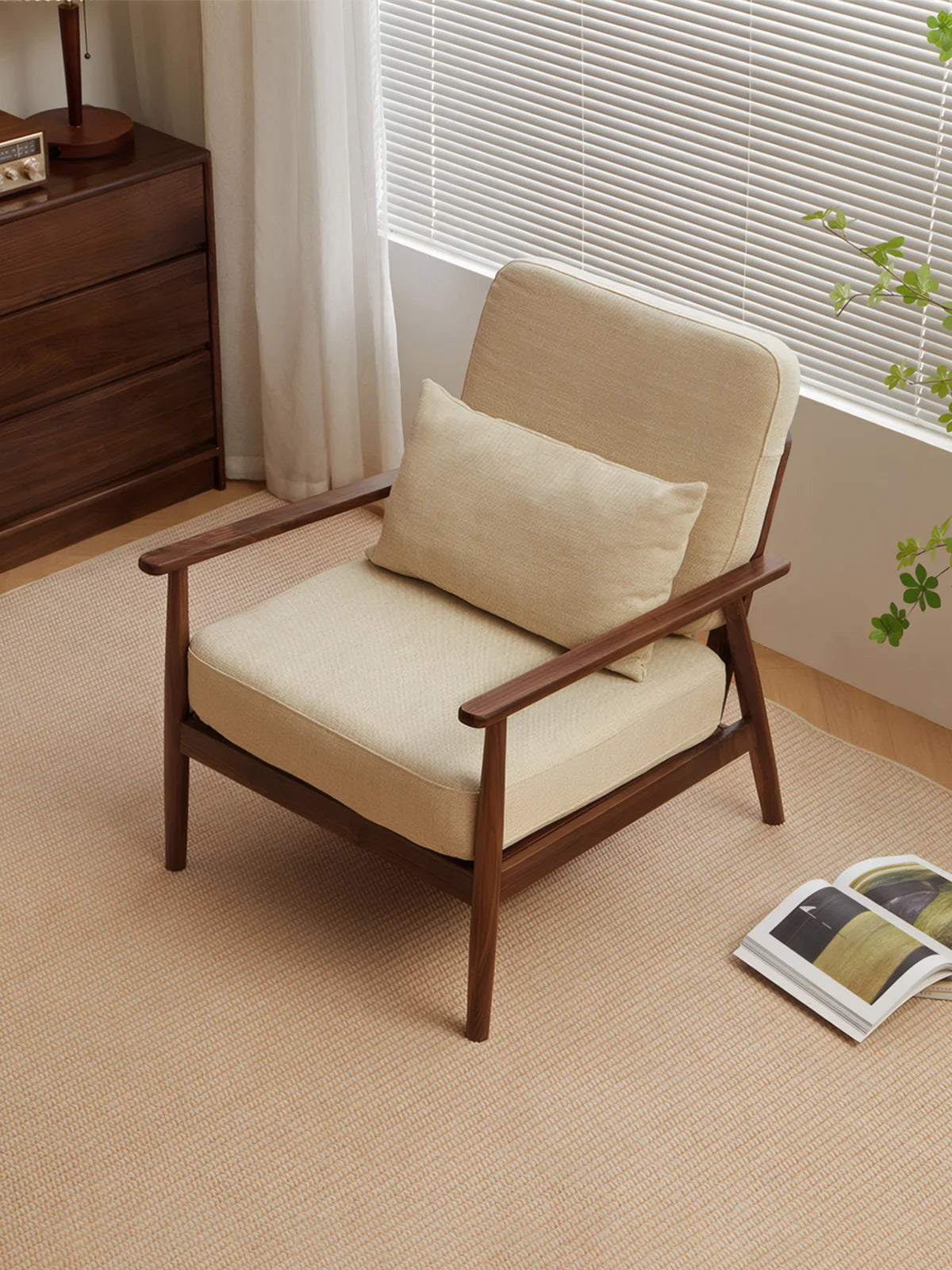 Walnutry Alden Armchair top-angle lifestyle image featuring a fabric accent armchair with walnut frame in a bright and calm reading corner