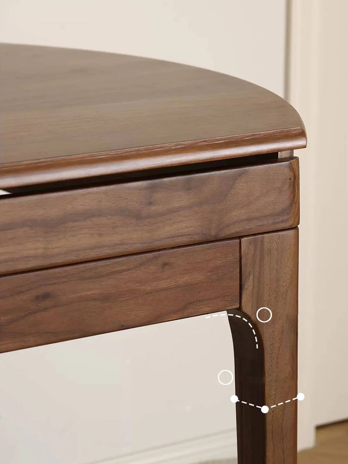 Detail view of the table corner and leg joinery, highlighting the rounded edge, apron, and smooth wood connections.