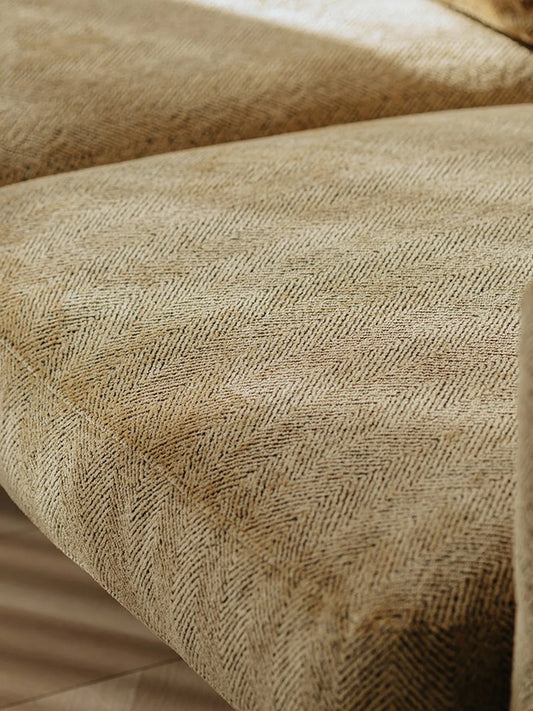Macro detail of herringbone-weave wheat fabric on the Alden Ridge sofa seat cushion