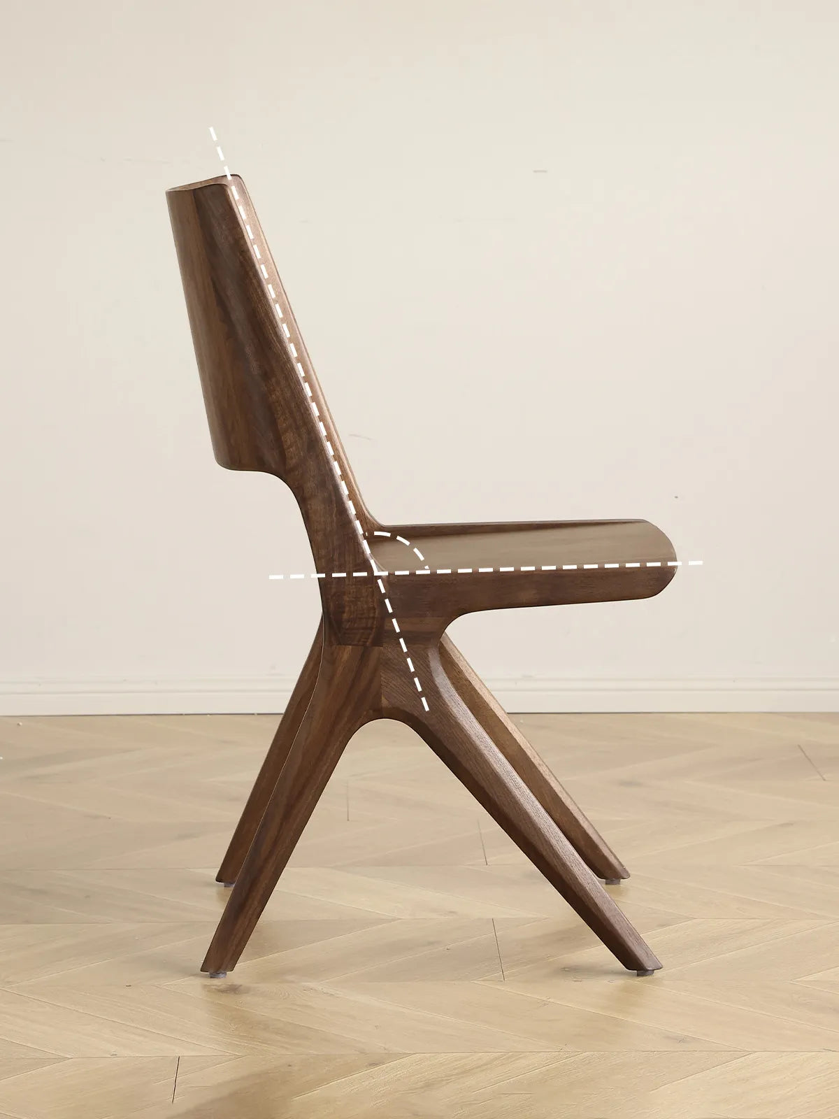 Detail of the Arlen Dining Chair backrest cutout with visible walnut grain.