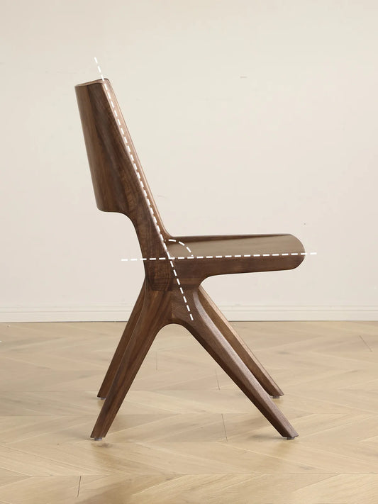 Detail of the Arlen Dining Chair backrest cutout with visible walnut grain.