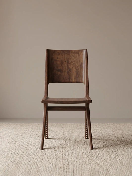 Front view of the Arlen Dining Chair in solid walnut, showing the horizontal backrest cutout and contoured seat.