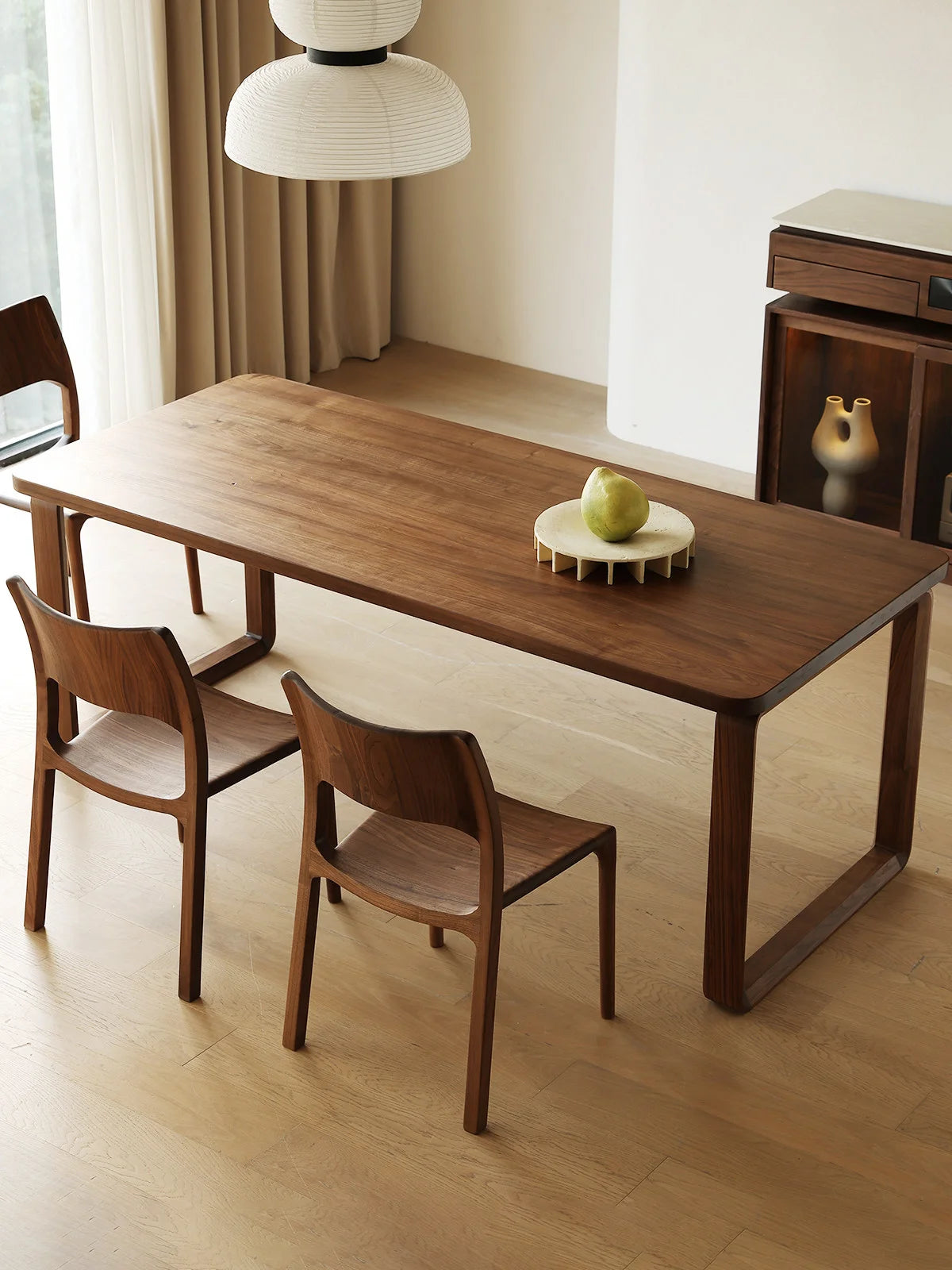 Top angled view of the Auren solid wood rectangle dining table in walnut with softly rounded edges and rich natural grain.