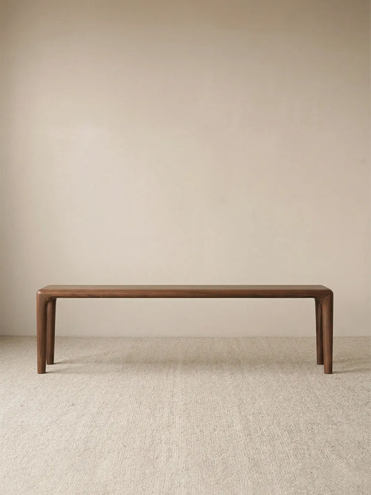 Auren Walnut Bench placed at the foot of the bed as a solid walnut bedroom bench in a calm, modern interior.