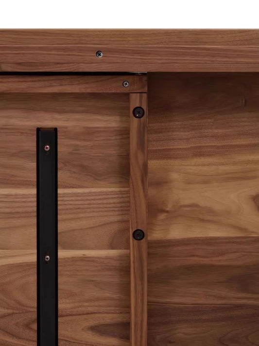 Underside detail of the solid walnut dining table showing support structure and hardware