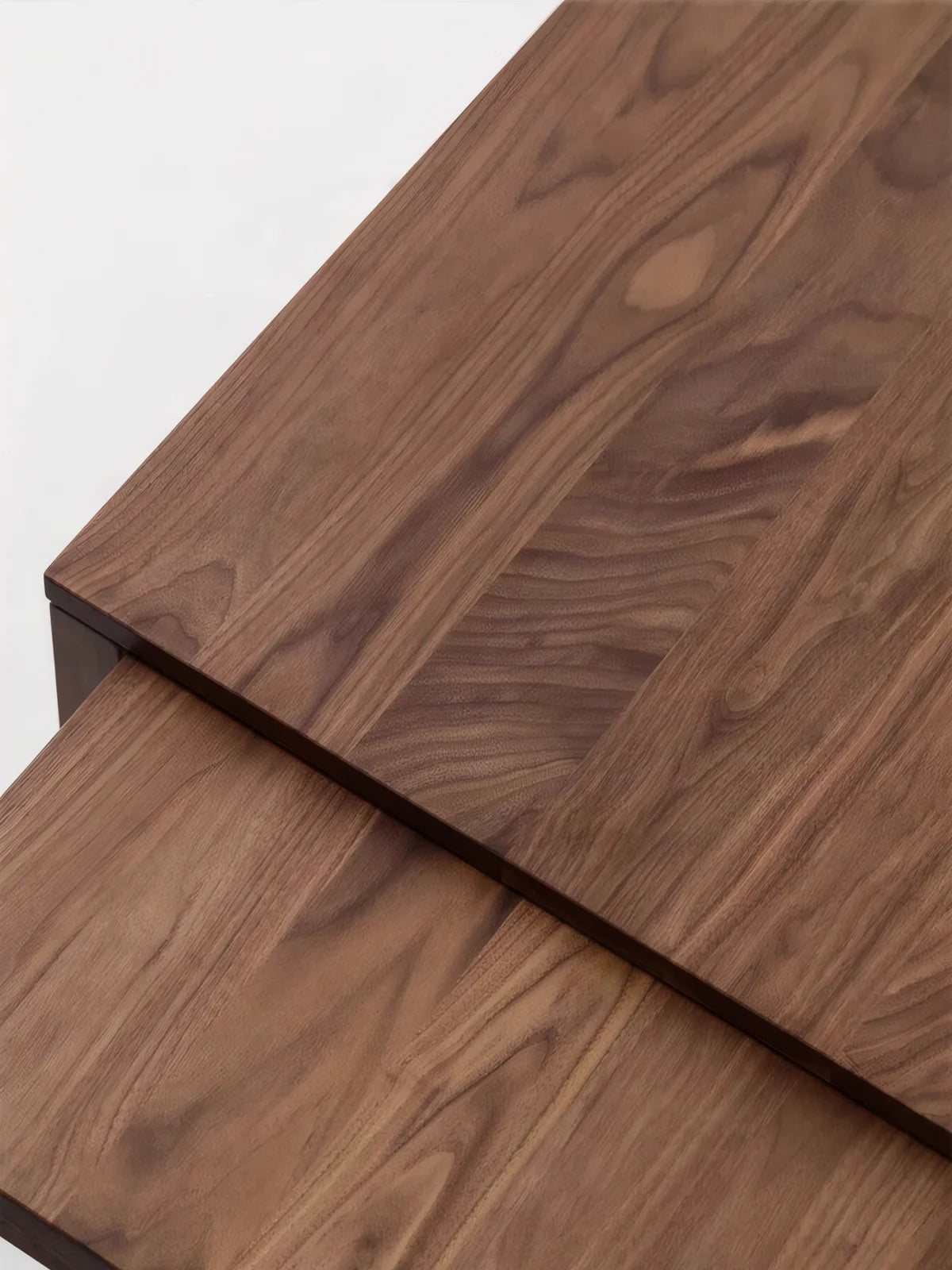 Detailed view of the walnut tabletop grain and overlapping sliding extension surface