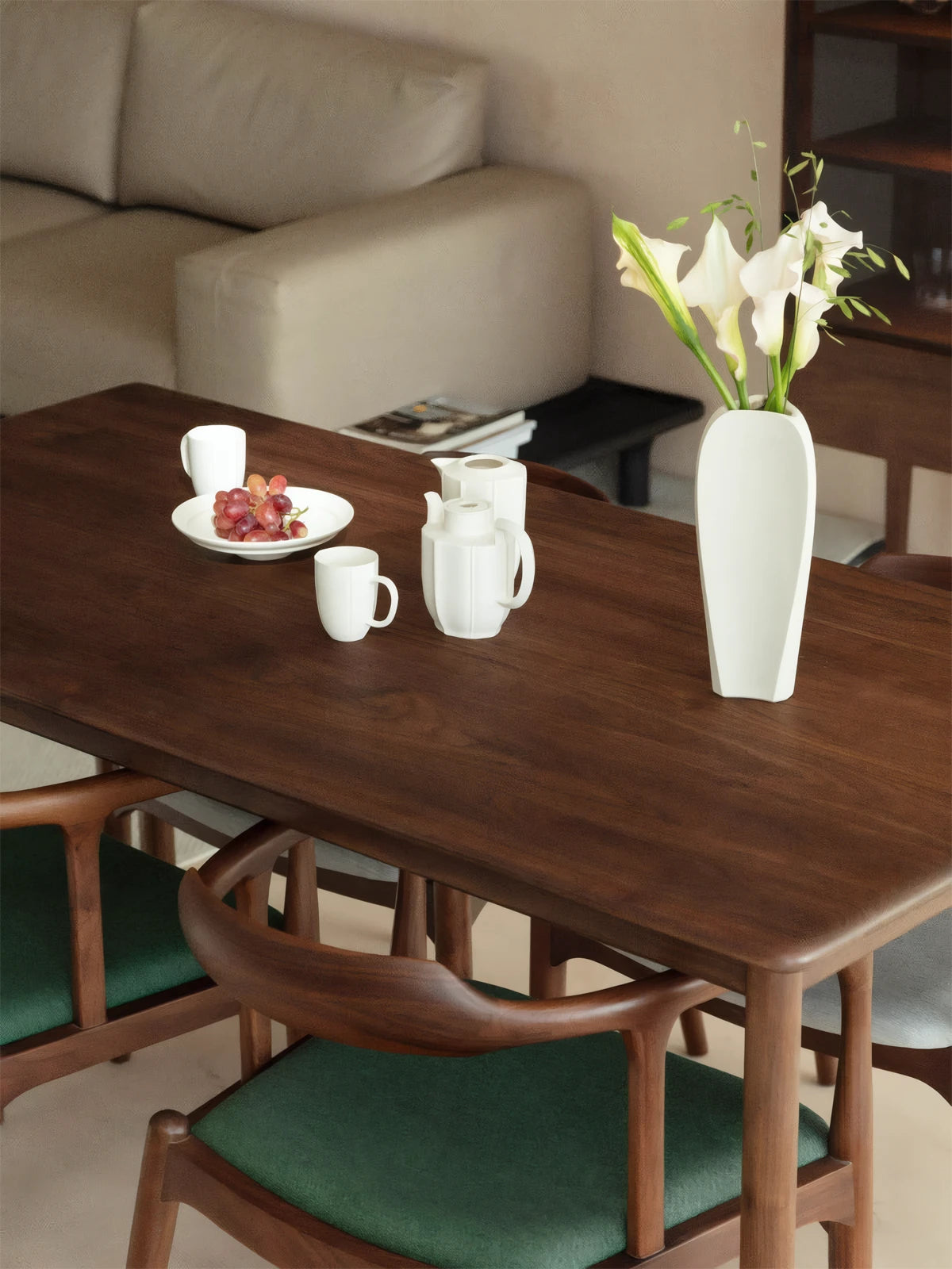 Overhead view of the Cumberland black walnut dining room table top, displaying the natural cathedral grain patterns and a minimalist white vase.
