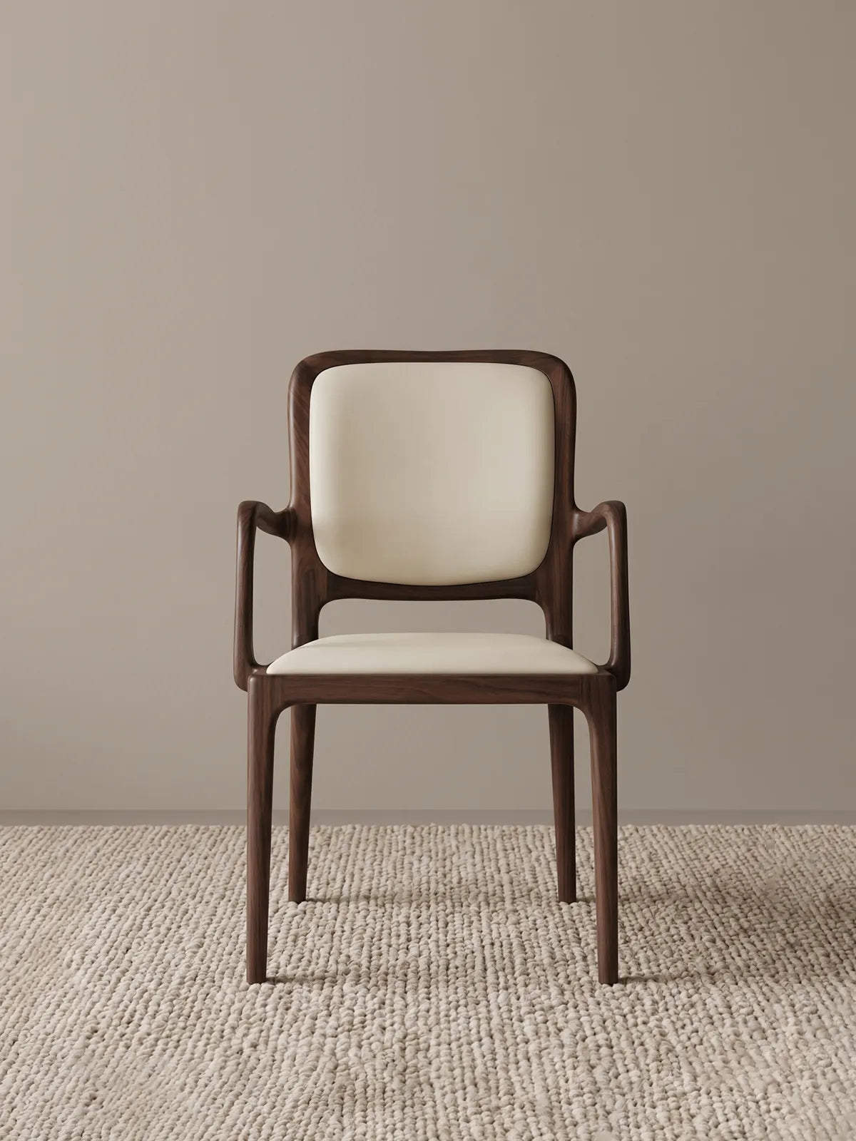 Front view of the Cael dining arm chair showing the solid walnut frame and cream upholstered seat and backrest against a neutral background.