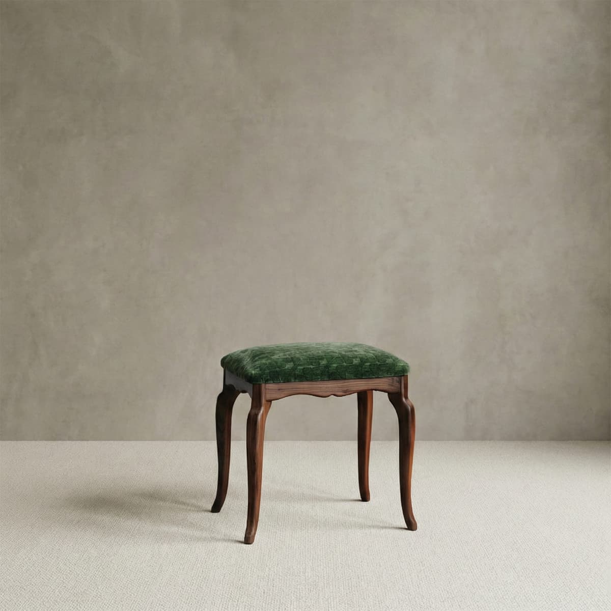 Vintage-inspired solid walnut vanity stool with elegant curved legs and a luxurious emerald green velvet upholstered seat.