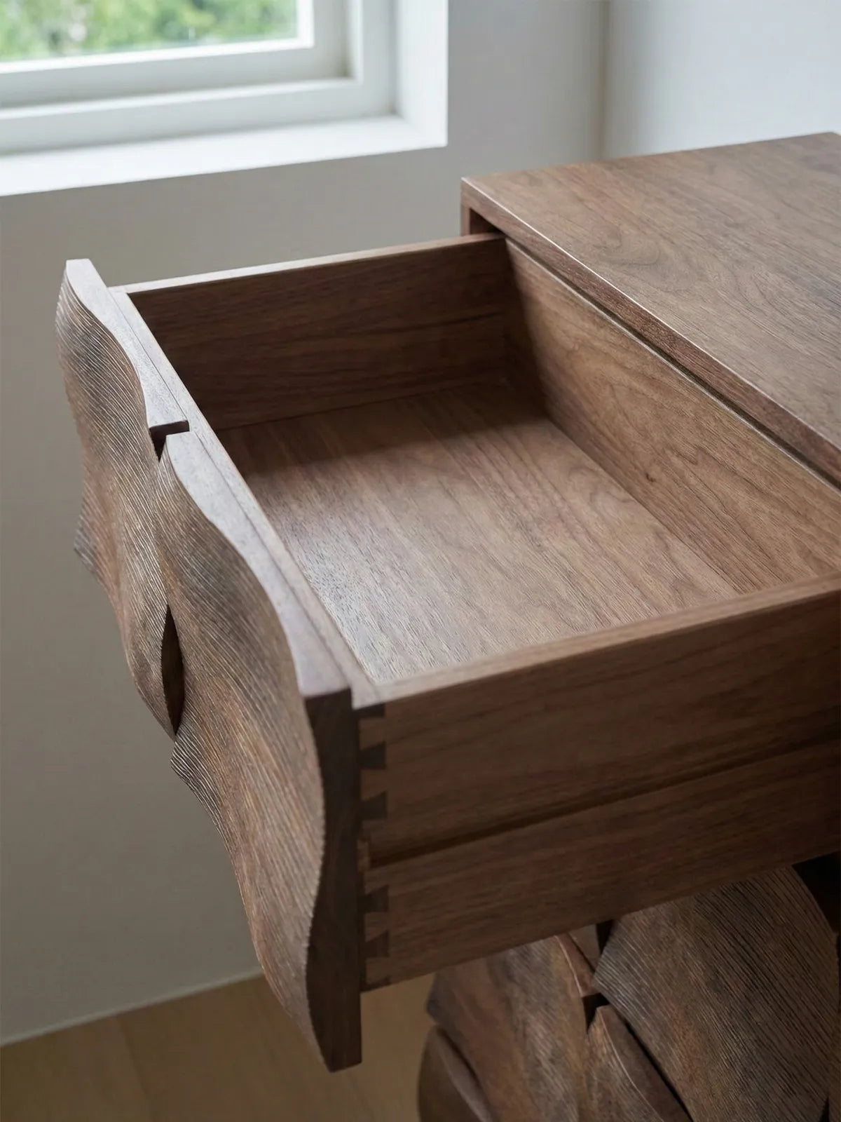 Open drawer of Cumberland chest revealing solid walnut construction and traditional English dovetail joinery for superior durability.