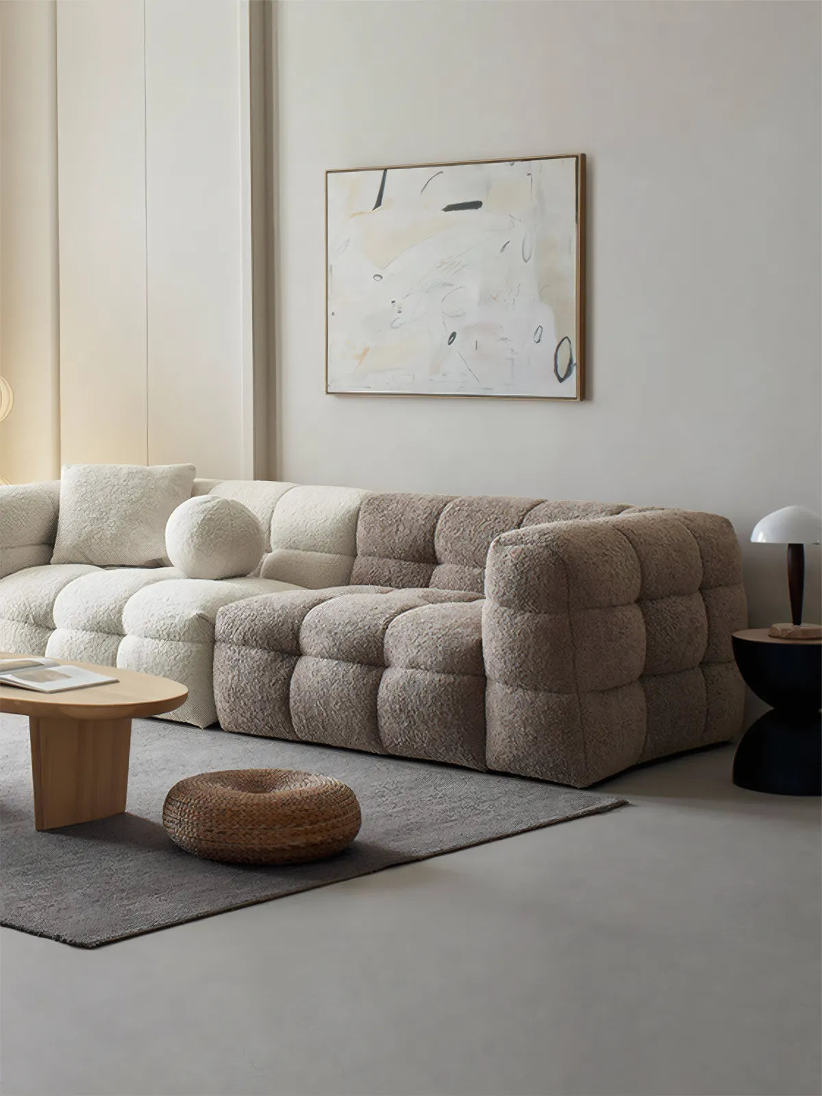 Walnutry Cumberland modular sectional sofa in white bouclé fabric, L-shape configuration in a modern organic living room with abstract art.