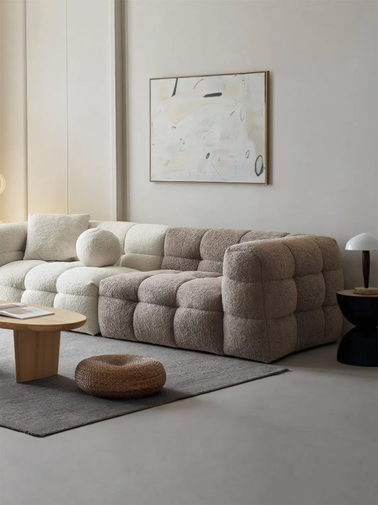 Walnutry Cumberland modular sectional sofa in white bouclé fabric, L-shape configuration in a modern organic living room with abstract art.