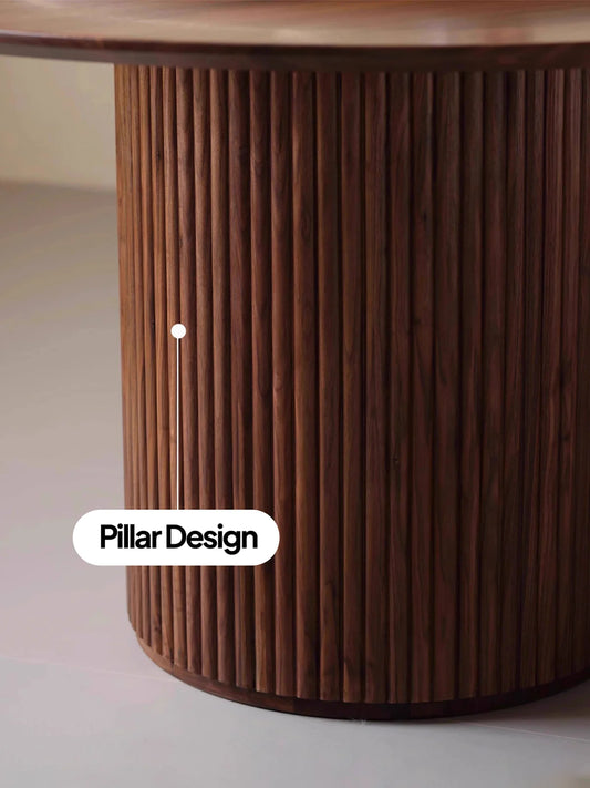 Detailed close-up of the fluted solid walnut pedestal base on a round dining table.