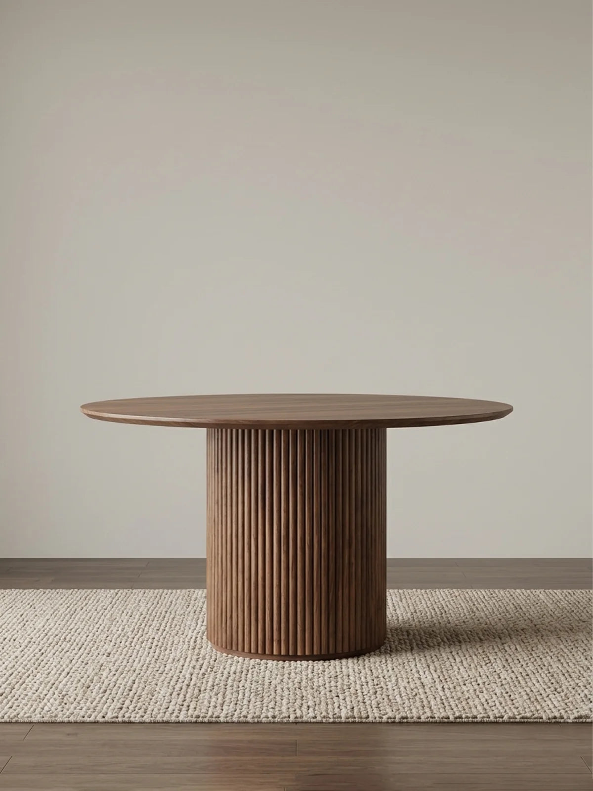 Front view of a solid American black walnut round pedestal dining table with a fluted pillar base and softly beveled top.