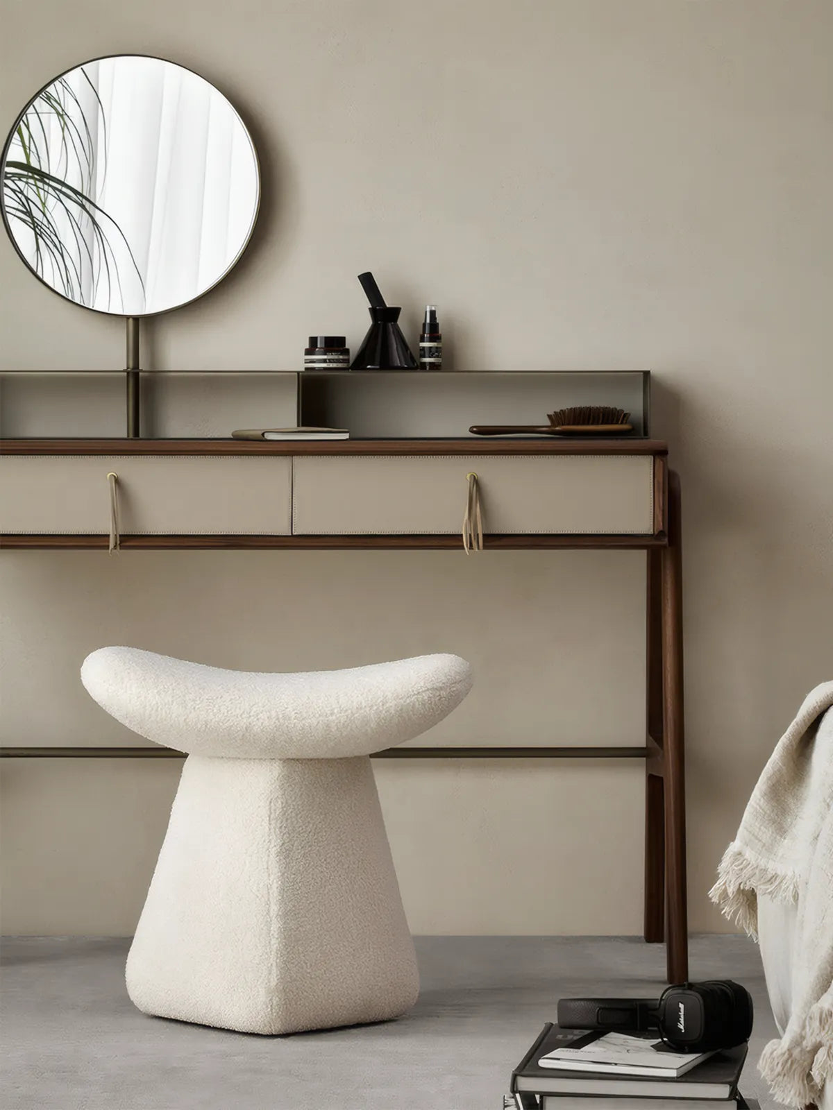 Front view of the Walnutry Cumberland mushroom stool featuring solid black walnut legs and cream bouclé upholstery, styled as a luxury vanity stool with a round mirror.