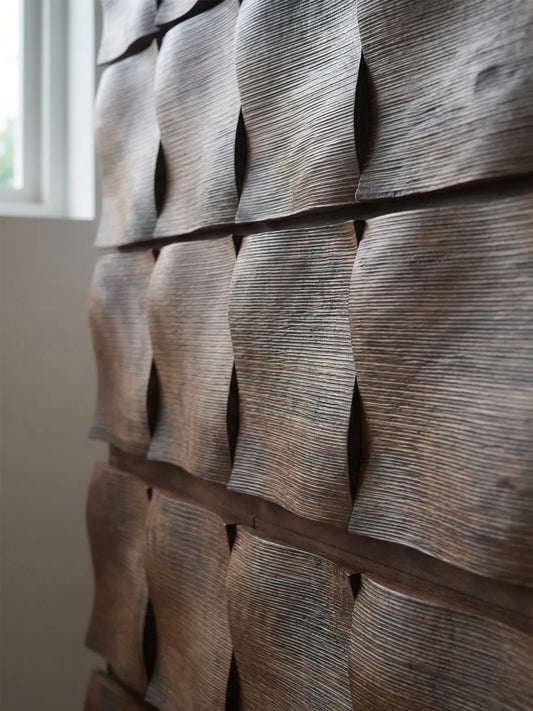 Macro detail shot of the handcrafted sculpted wave pattern on solid North American black walnut drawer fronts, highlighting rich grain and texture.