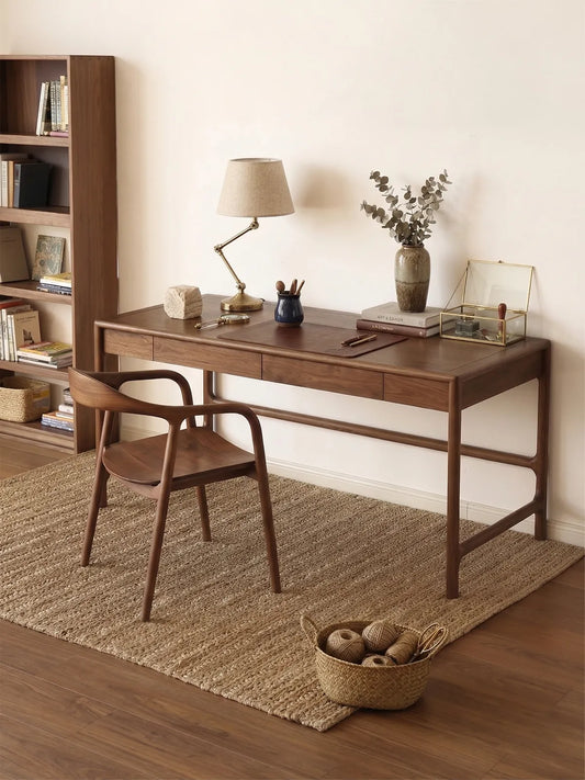 curved back walnut dining chair styled at a solid walnut writing desk in a warm minimalist interior