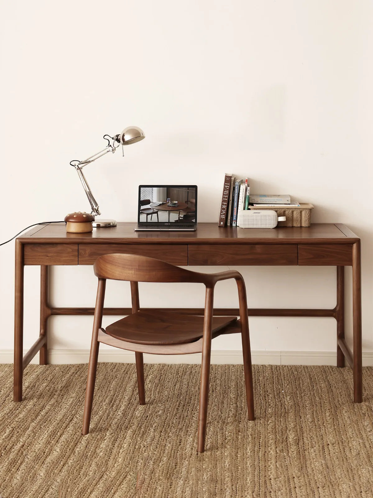 curved back walnut chair placed at a long walnut desk in a calm home office setting