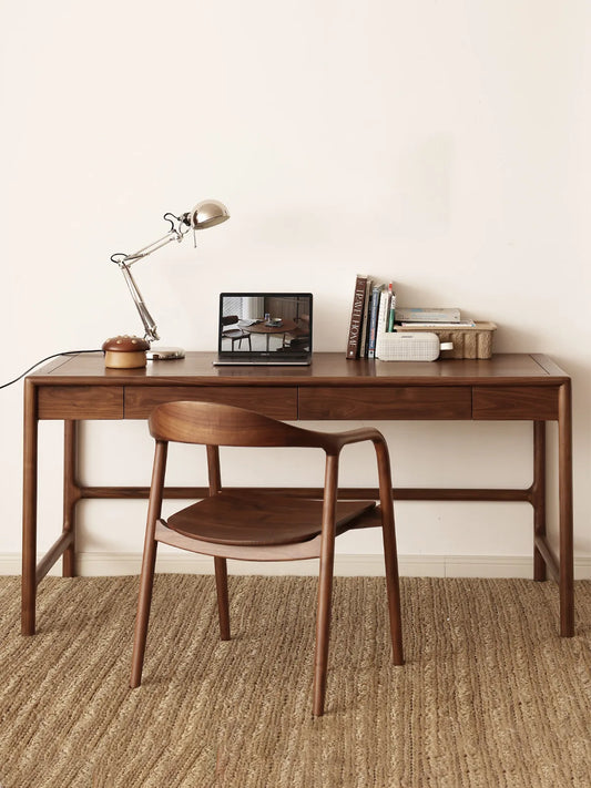 curved back walnut chair placed at a long walnut desk in a calm home office setting
