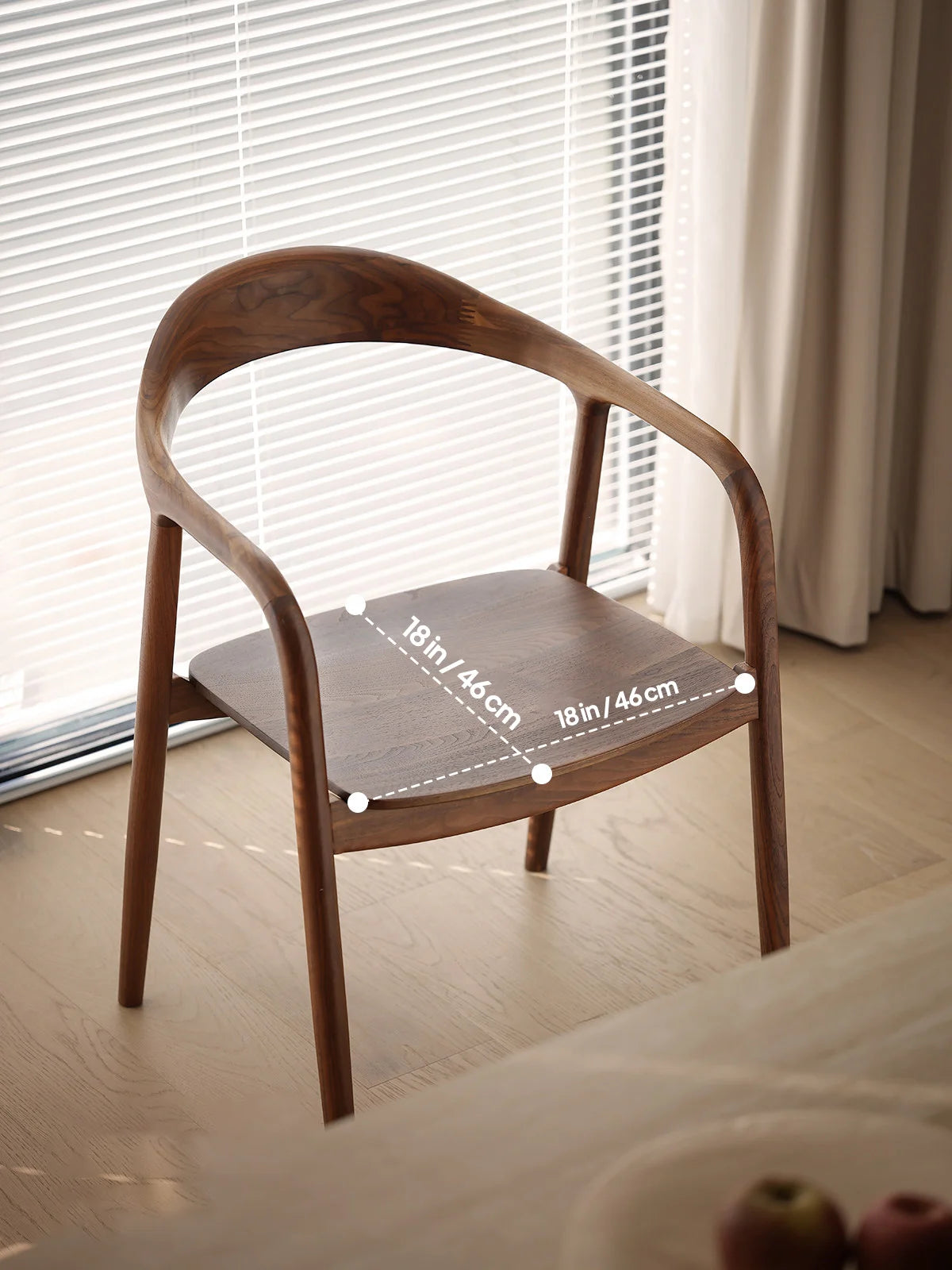 angled view of a curved back walnut dining chair showing the seat width and depth dimensions