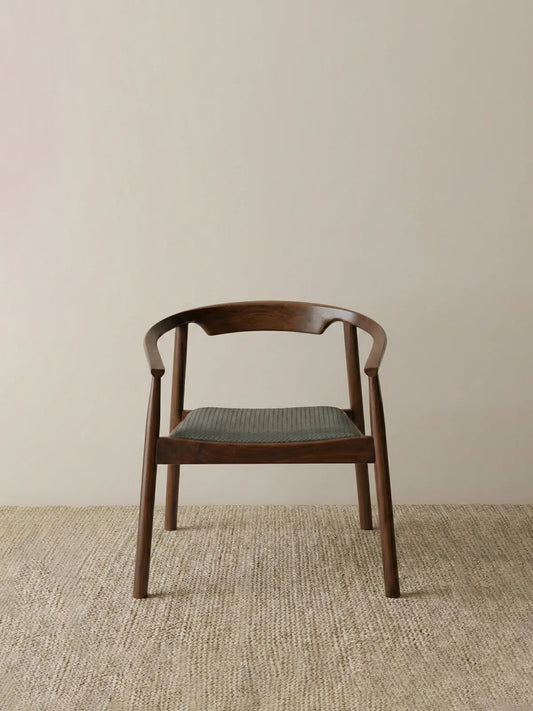 Walnutry handcrafted solid North American black walnut armchair with a curved backrest and a woven cord seat, inspired by classic Danish mid-century modern design.