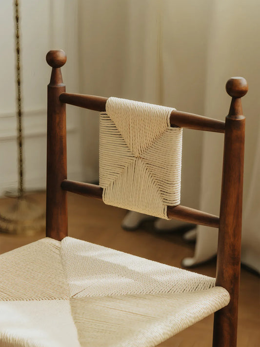 Detail of hand-woven paper cord backrest panel and ball finial posts on the Daren chair