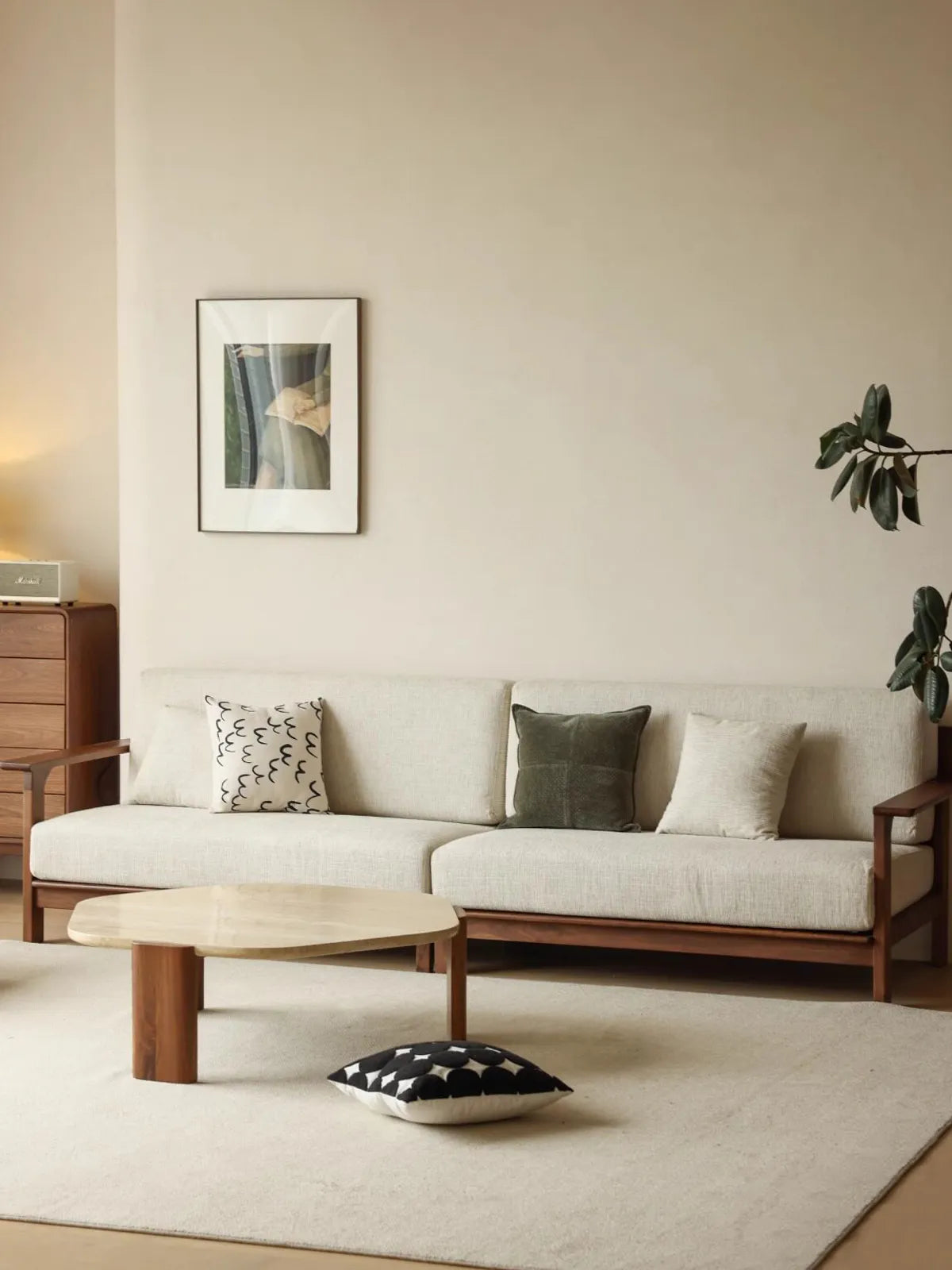 Daren 3-seater sofa in solid walnut frame with cream cushions styled in a living room with coffee table and plants