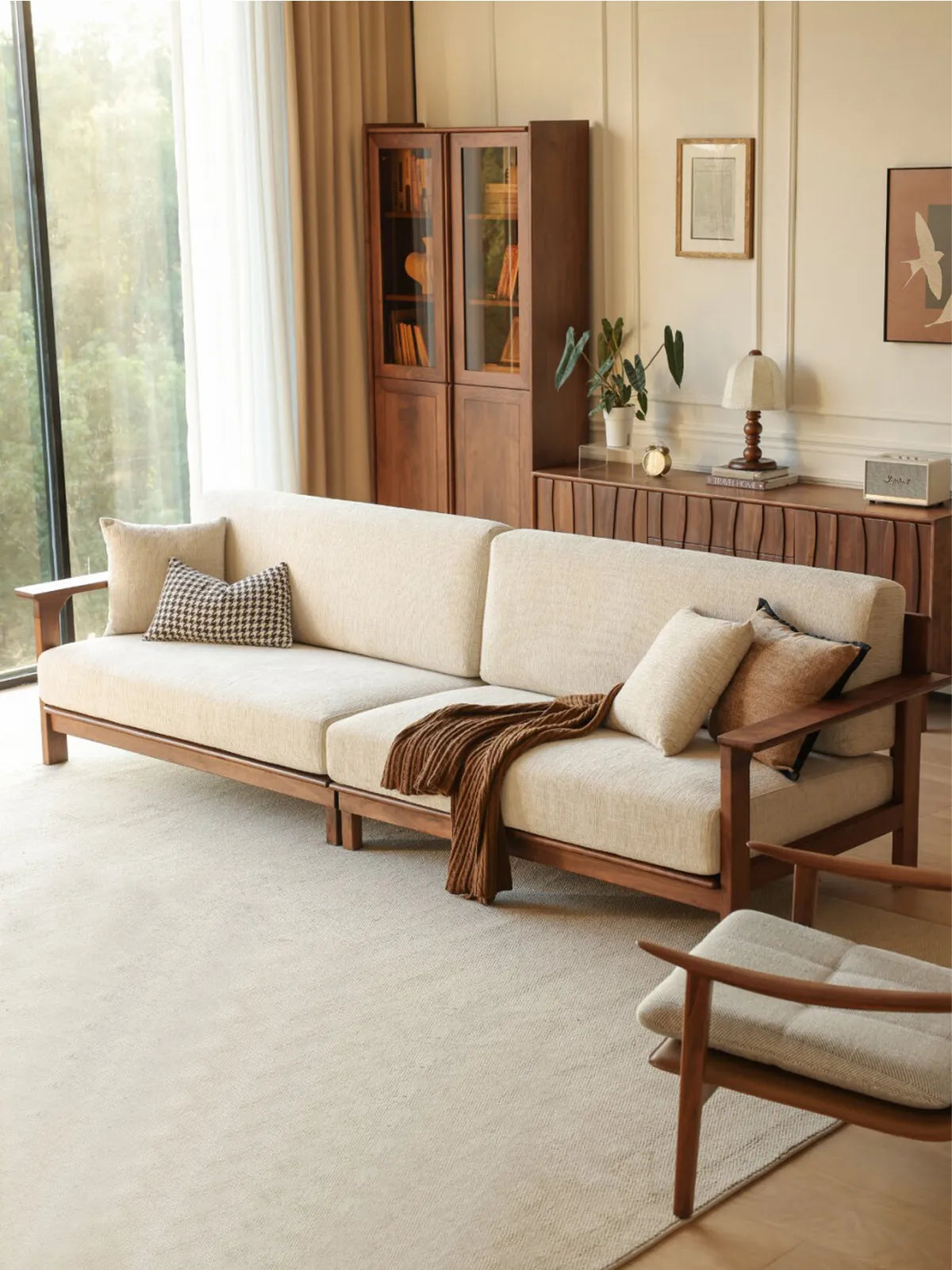 Daren 3-seater sofa viewed from the rear showing solid walnut frame, throw blanket, and styled living room