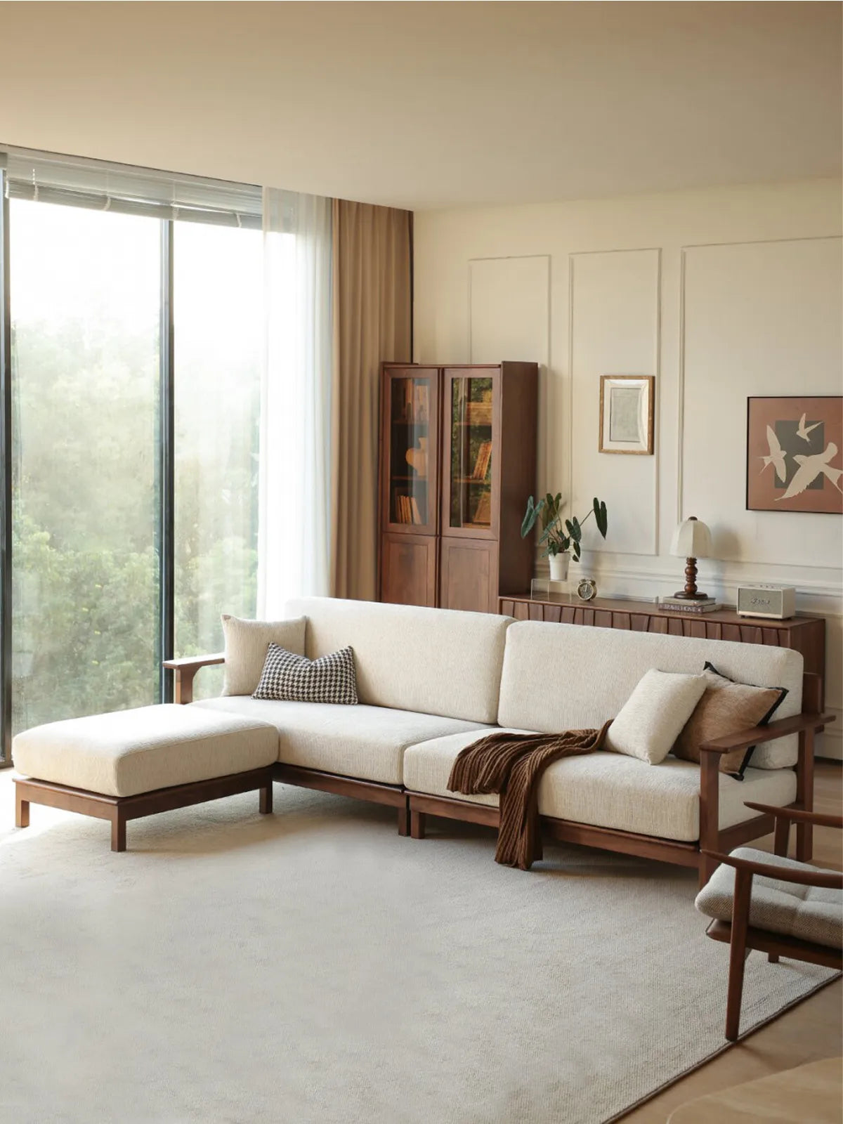 Daren sectional sofa with left chaise lounge viewed from the side in a bright living room with floor-to-ceiling windows