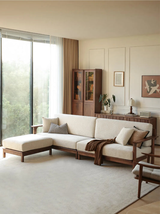 Daren sectional sofa with left chaise lounge viewed from the side in a bright living room with floor-to-ceiling windows
