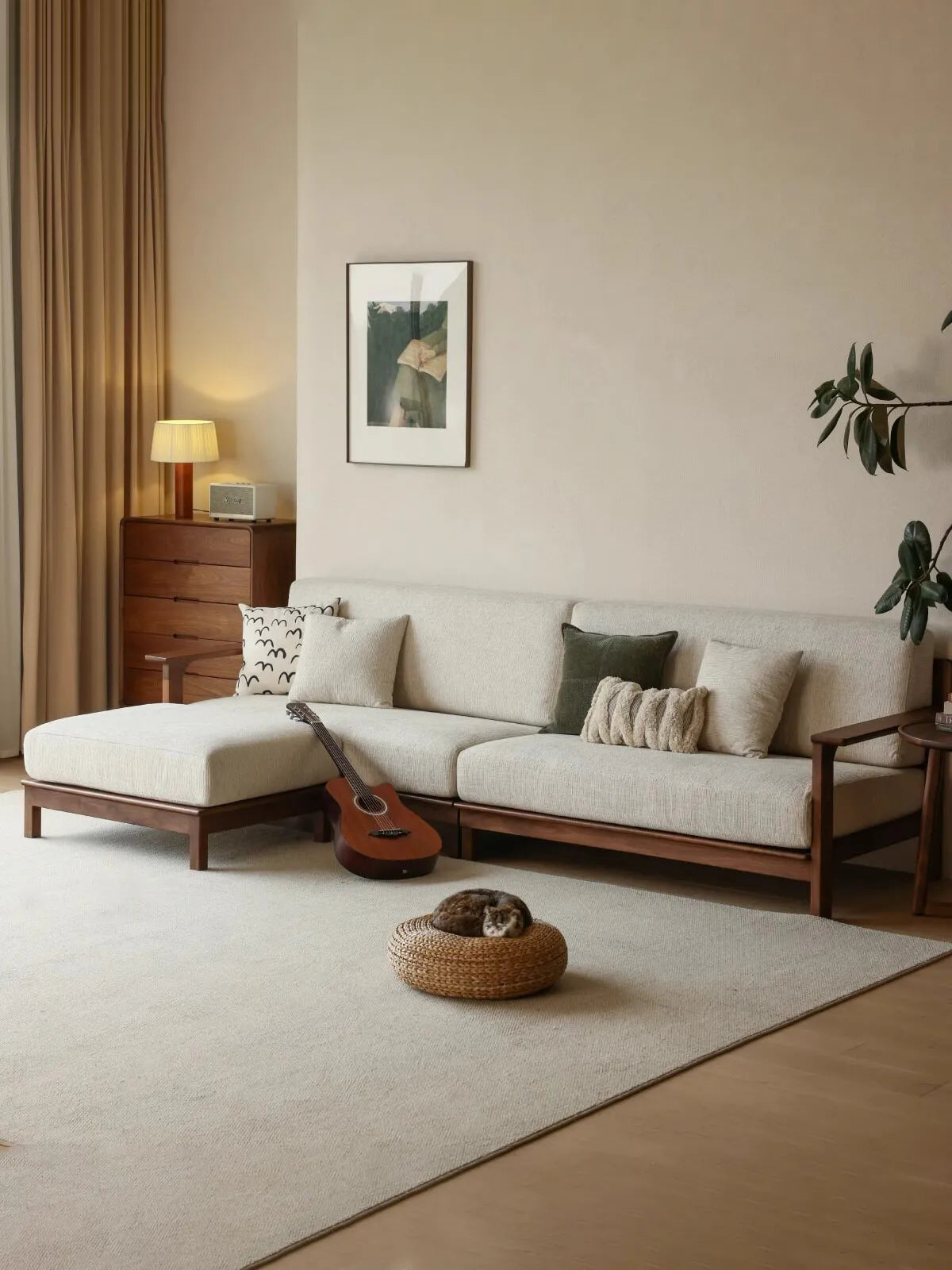Wide lifestyle view of the Daren sectional with chaise in a warm living room with guitar, cat, and natural light