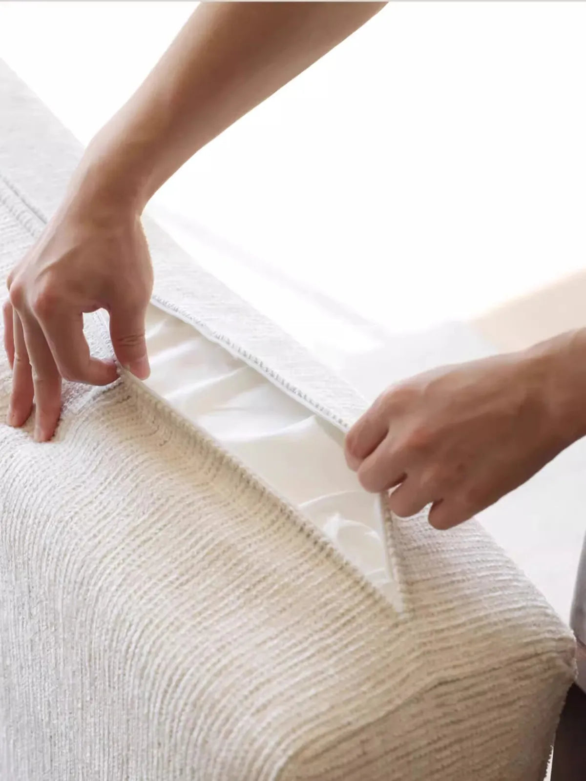 Close-up of removable zippered cushion cover on the Daren sofa showing concealed zipper and textured cream fabric