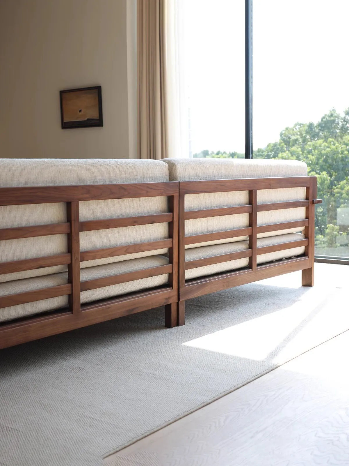 Rear view of the Daren sofa showing horizontal slatted walnut back construction and exposed wood joinery