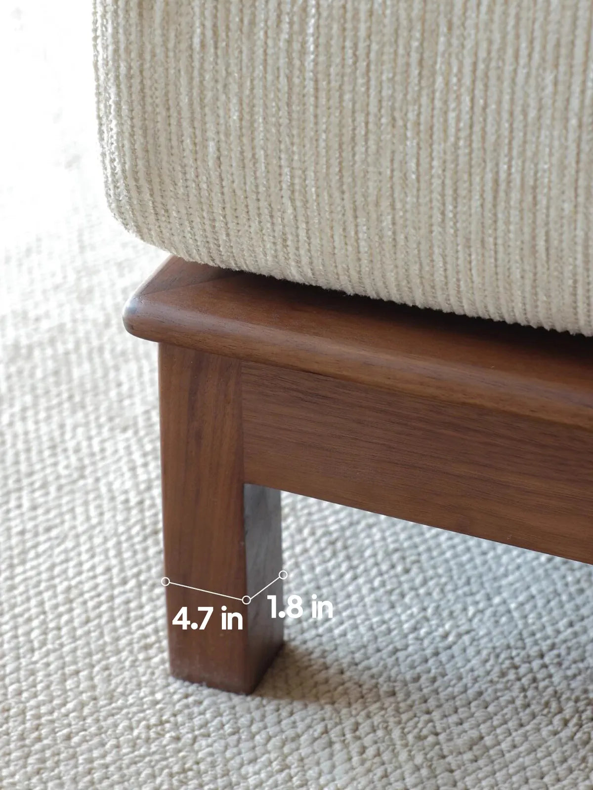 Detail of solid walnut leg on the Daren sofa showing 4.7 in width and 1.8 in depth dimensions