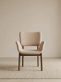 Front view of a beige upholstered dining chair with arms and solid walnut frame (Oatmeal)