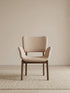 Front view of a beige upholstered dining chair with arms and solid walnut frame (Oatmeal)