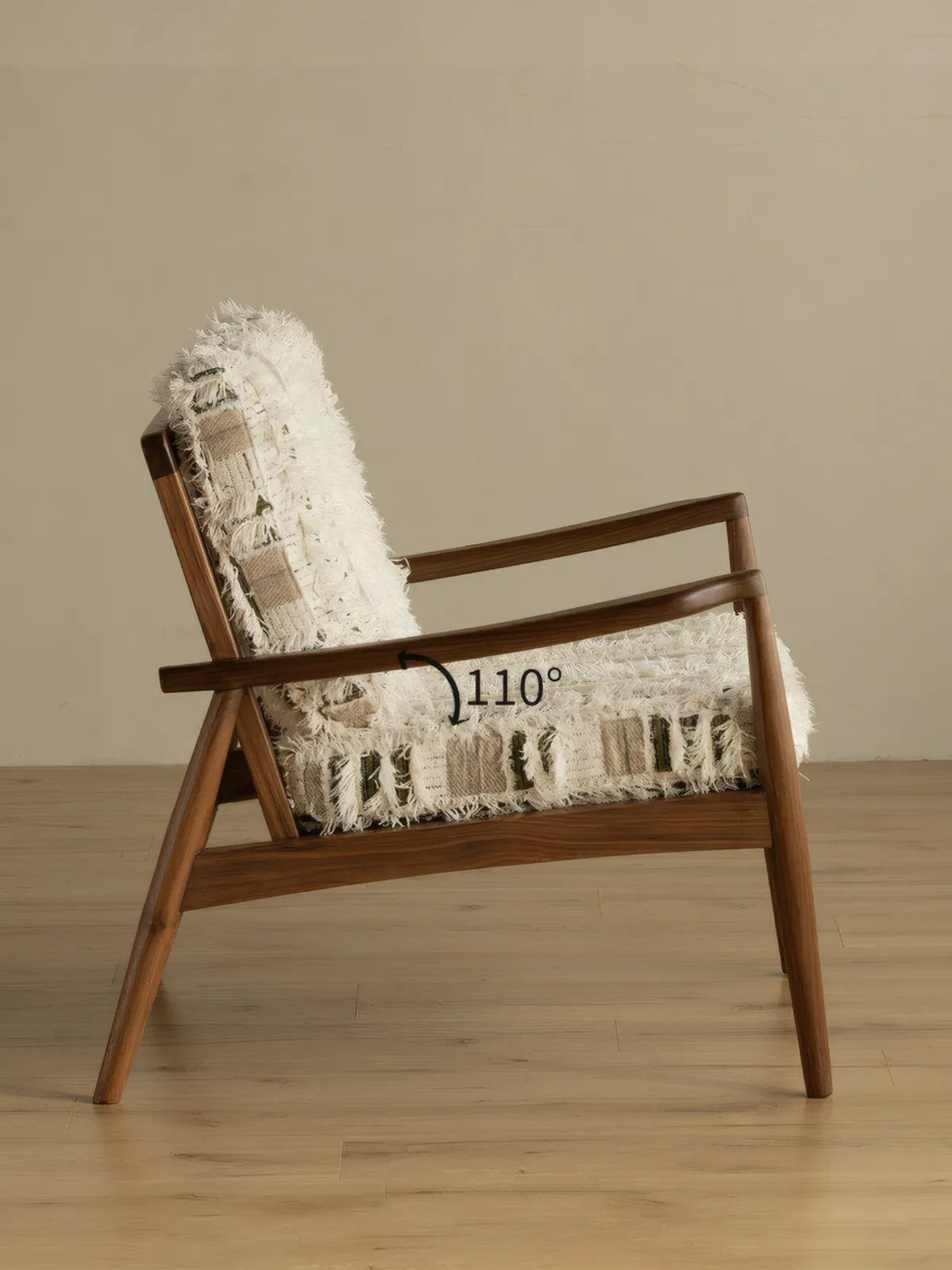 Eron lounge chair back view showing five vertical walnut spindles and woven cushion visible through back