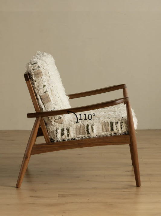 Eron lounge chair back view showing five vertical walnut spindles and woven cushion visible through back