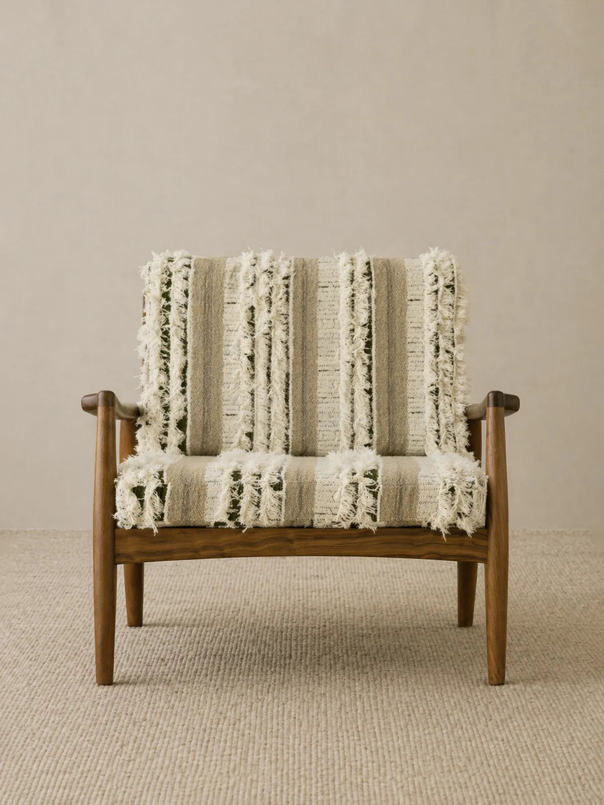 Eron lounge chair in solid walnut with cream and olive woven cushions, front view on neutral rug