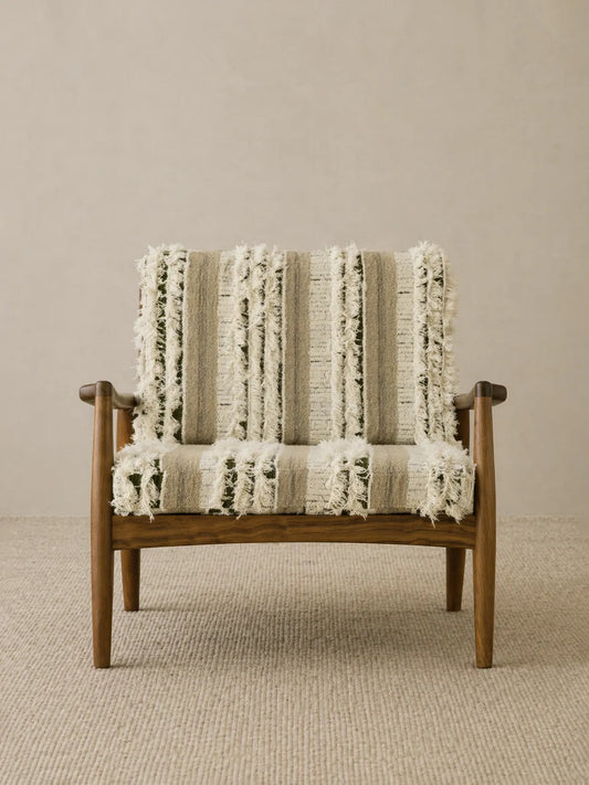 Eron lounge chair in solid walnut with cream and olive woven cushions, front view on neutral rug