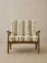Eron lounge chair in solid walnut with cream and olive woven cushions, front view on neutral rug