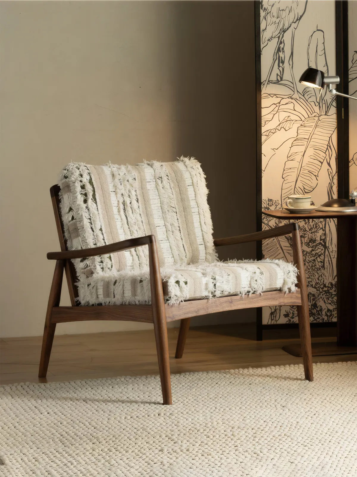 Eron walnut lounge chair three-quarter view in styled living room with side table and desk lamp