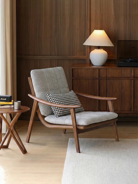 A cozy reading corner featuring the Haven mid century modern reading chair paired with a side table.