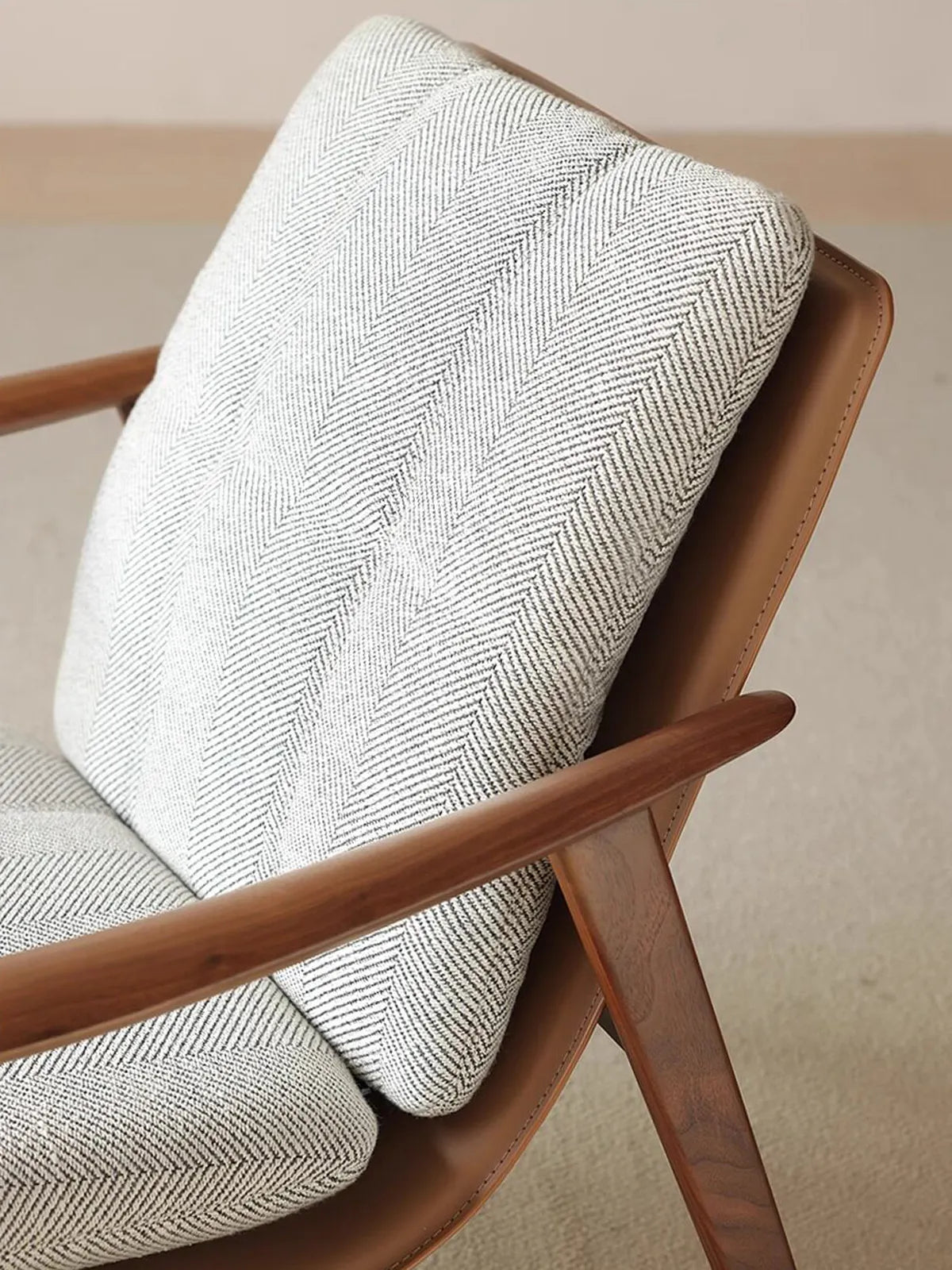 Top-down view of the smooth armrest on the Haven walnut accent chair, showcasing the rich wood grain.