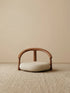 A clean studio front view of The Haven Wide-Seat Floor Chair, showcasing its thick, plush cushion and classic semi-circular walnut backrest.