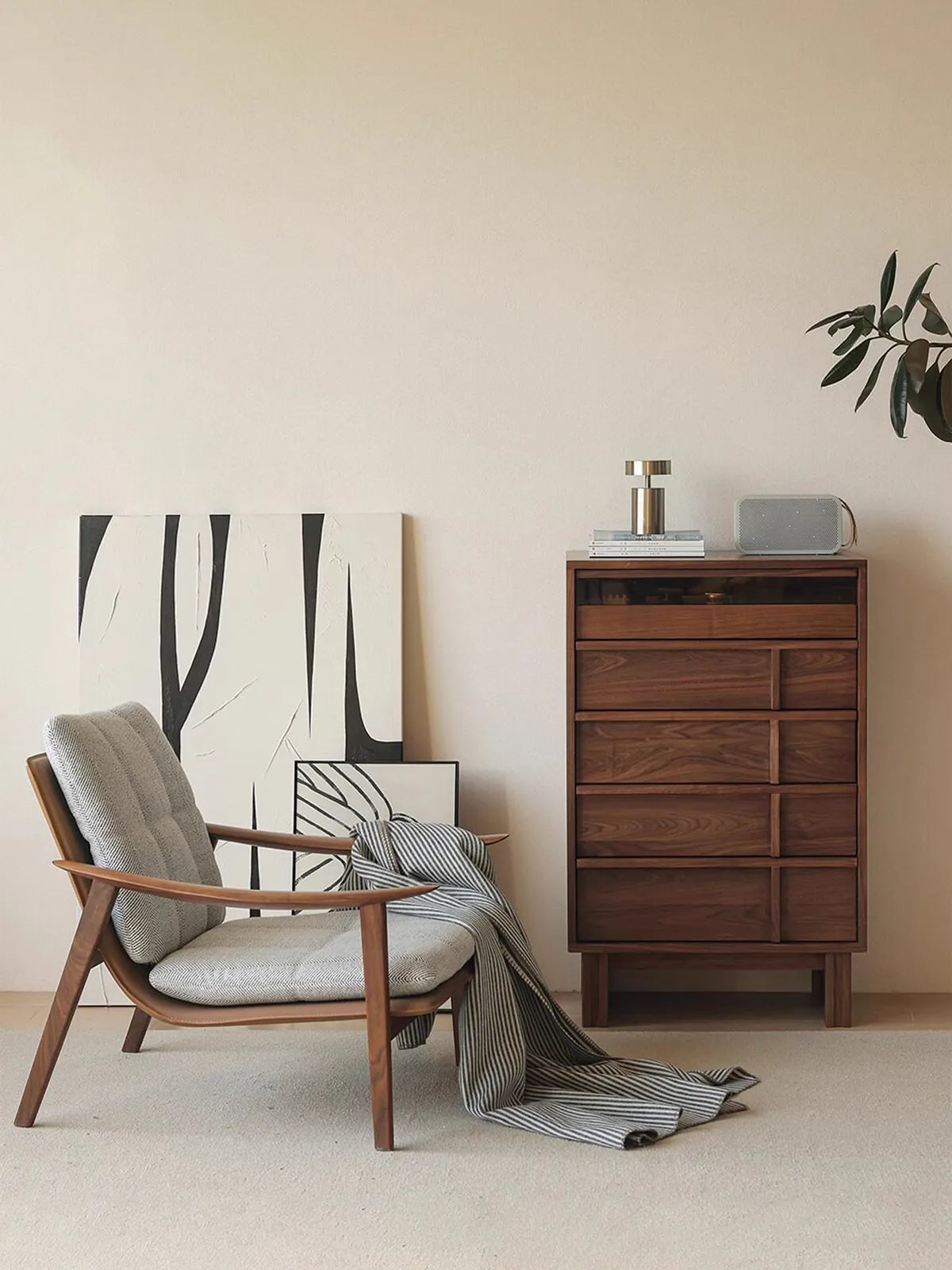 The Haven walnut accent chair styled in a modern living room next to a matching tall dresser.