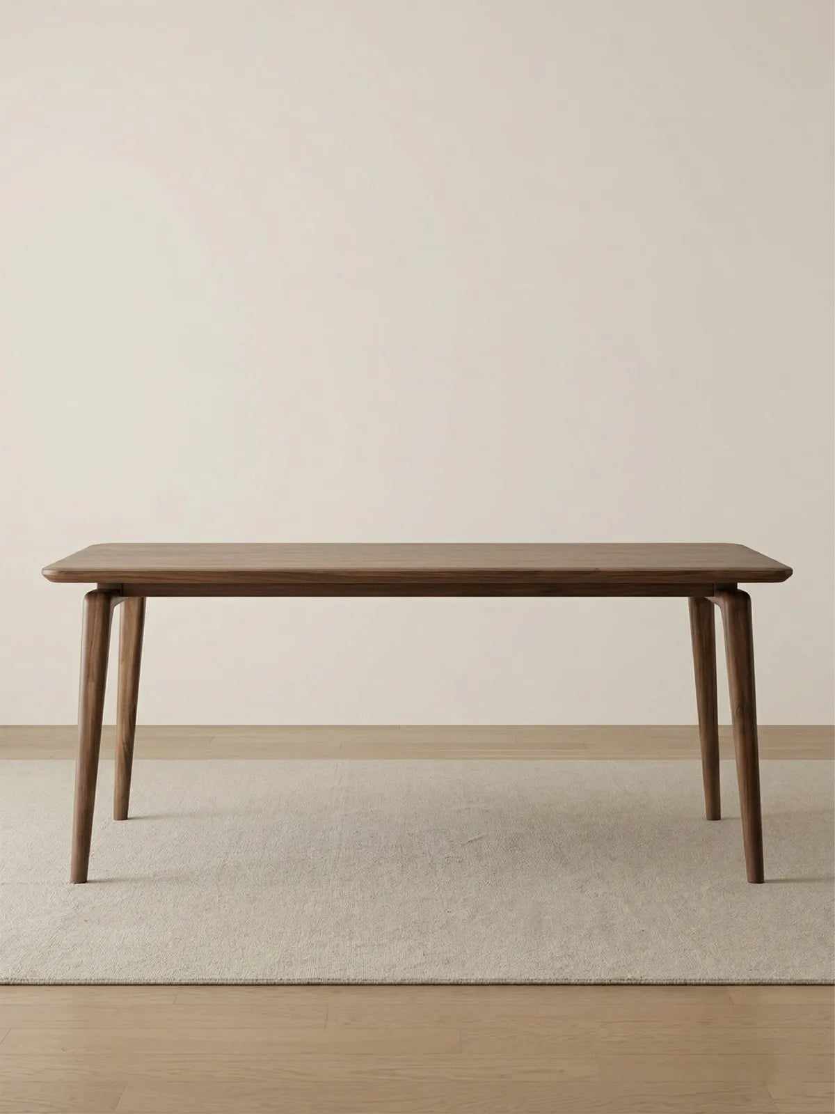 Minimalist studio shot of the Helios mid century modern solid wood dining table, highlighting its sleek profile and premium finish.