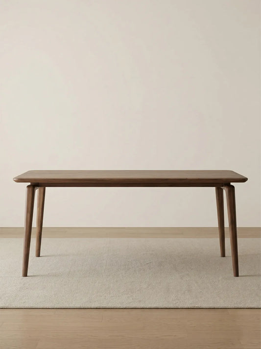Minimalist studio shot of the Helios mid century modern solid wood dining table, highlighting its sleek profile and premium finish.