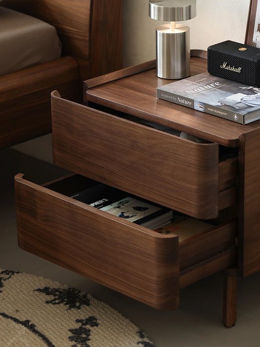 Both solid walnut drawers of The Helios Nightstand fully open, demonstrating spacious and organized bedside storage for books and personal items.
