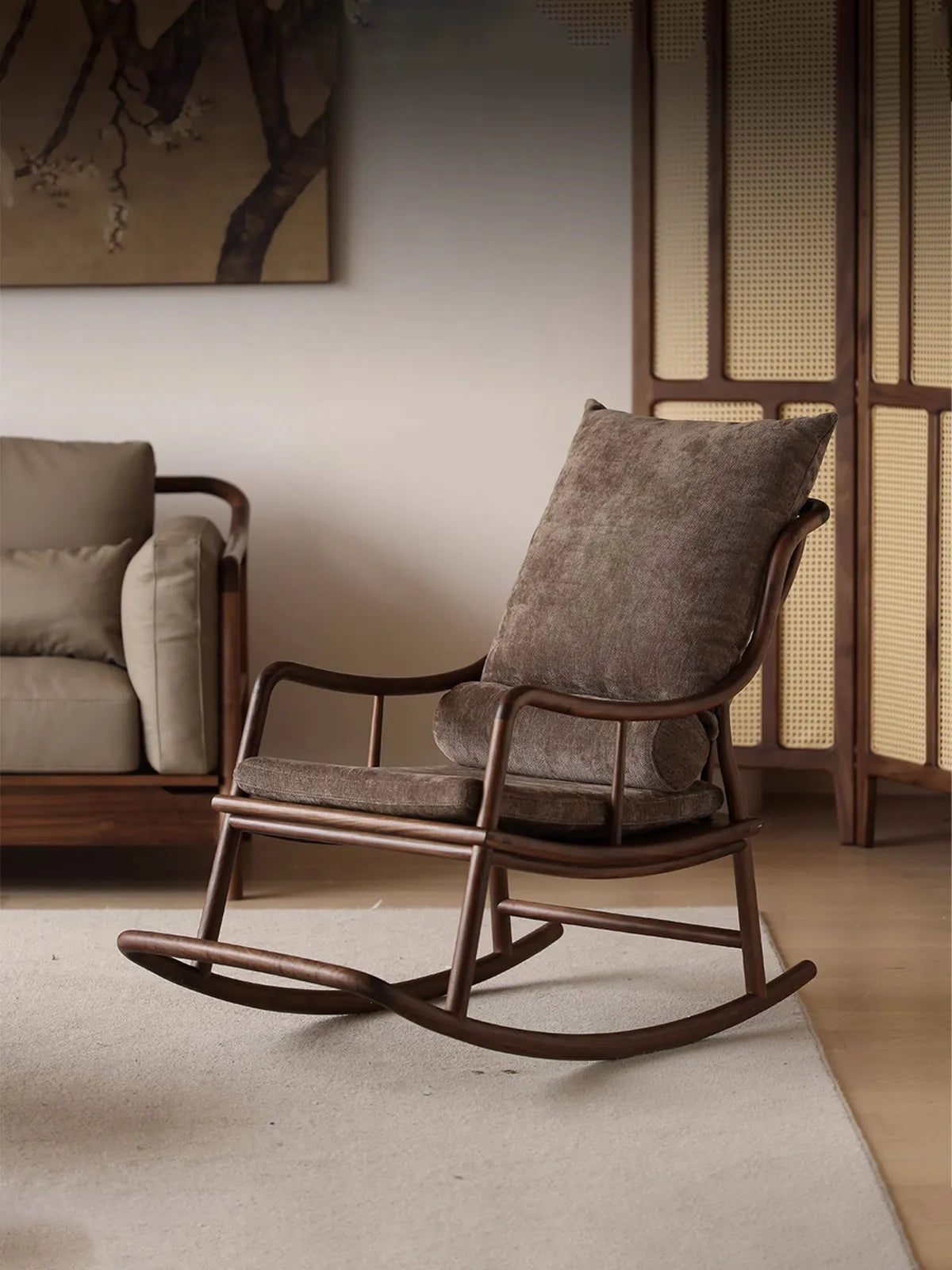 The Helios Rocking Chair with plush brown cushions styled in a cozy modern living room setting alongside other elegant furniture.